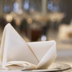 Napkin on plate at elegant place setting --- Image by © Fancy/Veer/Corbis